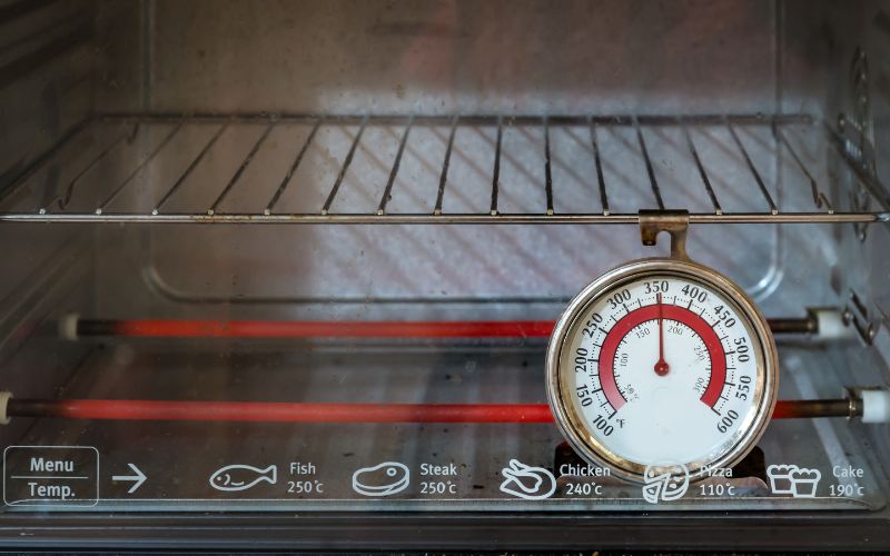 An oven thermometer inside an oven