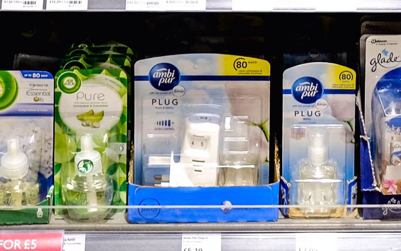 several brands of plug in air fresheners on a shelf