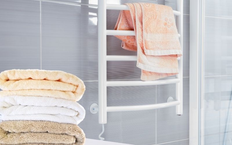 Image showing folded towels and a towel hanging on the towel warmer rail_Can a Towel Warmer Catch on Fire